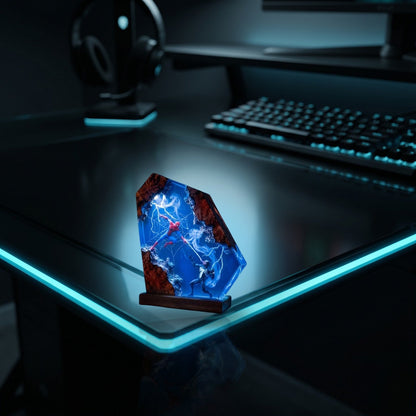 Resylume Portal Duel resin lamp on a gaming desk with cyan lighting